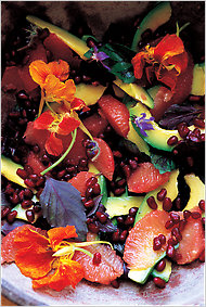 pink grapefruit avocado and pomegranate salad with nasturtium flowers